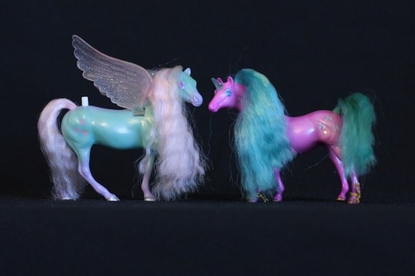 Meri & Shala; <h2>Meri</h2> Body Color:Teal and Purple <br/>Hair Color: Pink<br/>Breed: Pegasus Pink Wings<br/>Symbol: 3 Pink Hearts<br/>Brush: Purple<br/> Accessories: 2 Medium Purple Ribbons<br/>Notes: Tail Braided <h2>Shala</h2>  Body Color: Hot Pink<br/>Hair Color: Turquois<br/>Breed: Unicorn Teal Horn<br/>Symbol: I'm not sure what they actually are, but there are three pointy horseshoes with a bump on top<br/> Accessories: 2 Hot Pink Ribbons<br/>Notes: <br />Trading Card Story: Meri is the most artistic and creative of the Fillies. She loves to tell wild stories of her adventures in the sky and to make beautiful hairstyles on the other Fillies. Shala, her best Unicorn friend, always is available to let Meri style her hair! She loves the attention she gets when she models the new style!