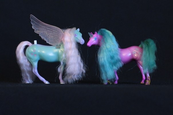 Meri & Shala; <h2>Meri</h2> Body Color:Teal and Purple <br/>Hair Color: Pink<br/>Breed: Pegasus Pink Wings<br/>Symbol: 3 Pink Hearts<br/>Brush: Purple<br/> Accessories: 2 Medium Purple Ribbons<br/>Notes: Tail Braided <h2>Shala</h2>  Body Color: Hot Pink<br/>Hair Color: Turquois<br/>Breed: Unicorn Teal Horn<br/>Symbol: I'm not sure what they actually are, but there are three pointy horseshoes with a bump on top<br/> Accessories: 2 Hot Pink Ribbons<br/>Notes: <br />Trading Card Story: Meri is the most artistic and creative of the Fillies. She loves to tell wild stories of her adventures in the sky and to make beautiful hairstyles on the other Fillies. Shala, her best Unicorn friend, always is available to let Meri style her hair! She loves the attention she gets when she models the new style!