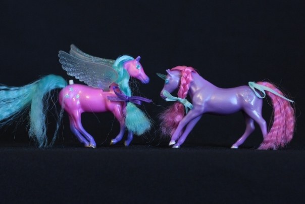 Storm & Zoe; <h2>Storm</h2> Body Color: Dark Pink and Purple<br/>Hair Color: Teal <br/>Breed: Pegasus Clear (maybe very pale Teal)<br/>Symbol: 3 Teal 5-point Stars <br/>Brush: Teal<br/> Accessories: 2 Dark Purple Ribbons<br/>Notes: <h2>Zoe</h2>  Body Color: Purple<br/>Hair Color: Dark Pink <br/>Breed: Unicorn Clear (maybe very light Teal) Horn <br/>Symbol: White Sparkles and Dots <br/> Accessories: 2 White Ribbons <br/>Notes: Tail in a twisted Braid. <br/>Trading Card Story: Storm likes to fly at the speed of lightening. Her powerful wings cause great gusts of wind to whip around the Unicorns on the ground. Zoe and the other Unicorns love to chase and play with the leaves and flowers that fall from the trees. Zoe's crystal horn reflects the lightening causing a beautiful spectrum of colors.